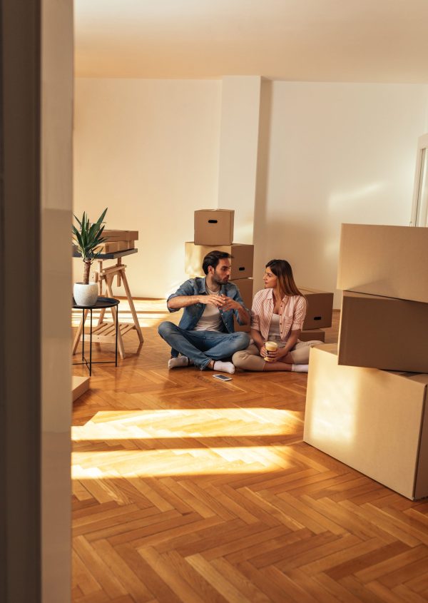 We’re going to make many great memories in our new home Happy young couple sitting on the floor in their new home and taking a rest while surrounded by boxes